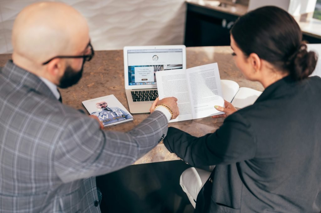office workers reviewing a book